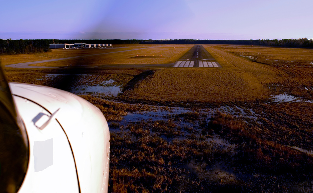 Cessna on approach at a rural airport in early spring