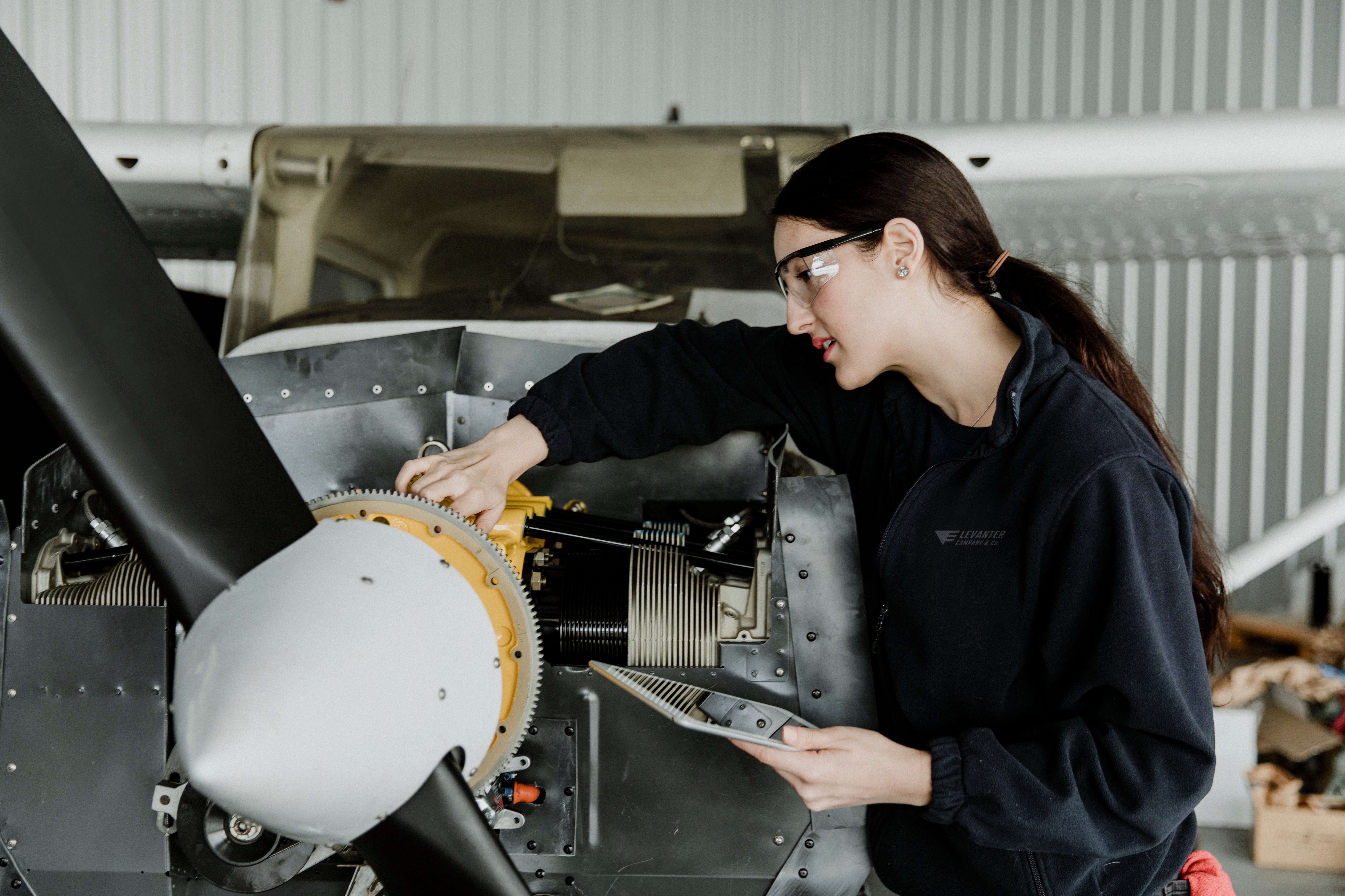 Aircraft mechanic testing exhaust system