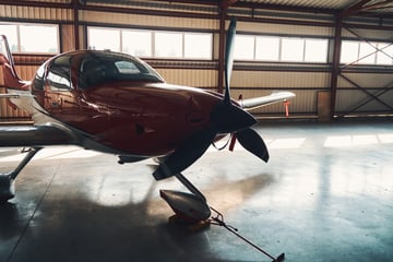 Cirrus tied down in a hangar