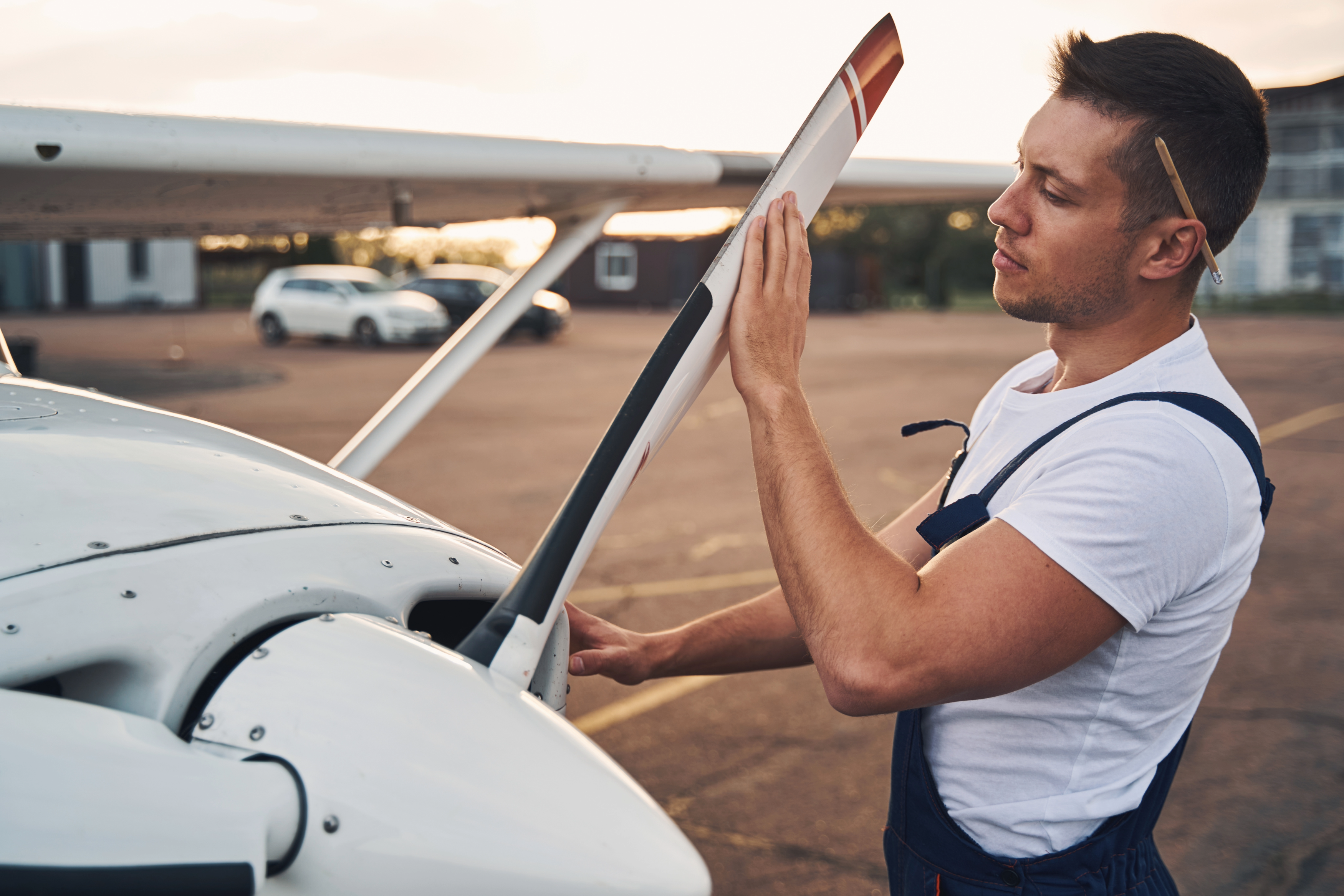Pilot inspecting airplane propeller