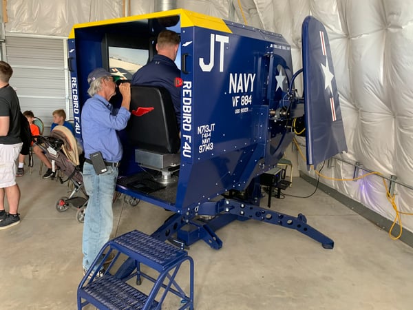 Flying a custom Redbird F4U Corsair flight simulator in the Warbird Youth Education Center at AirVenture