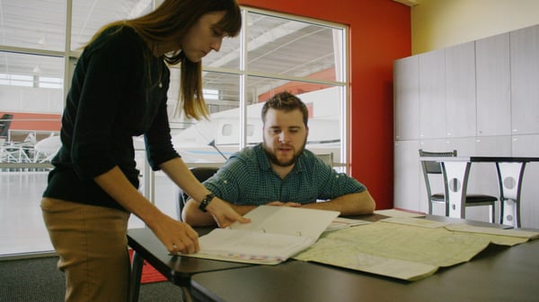 Ground instructor and student reviewing ground school materials