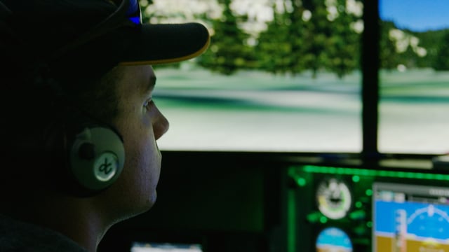 A pilot practices his skills with a Redbird flight simulator