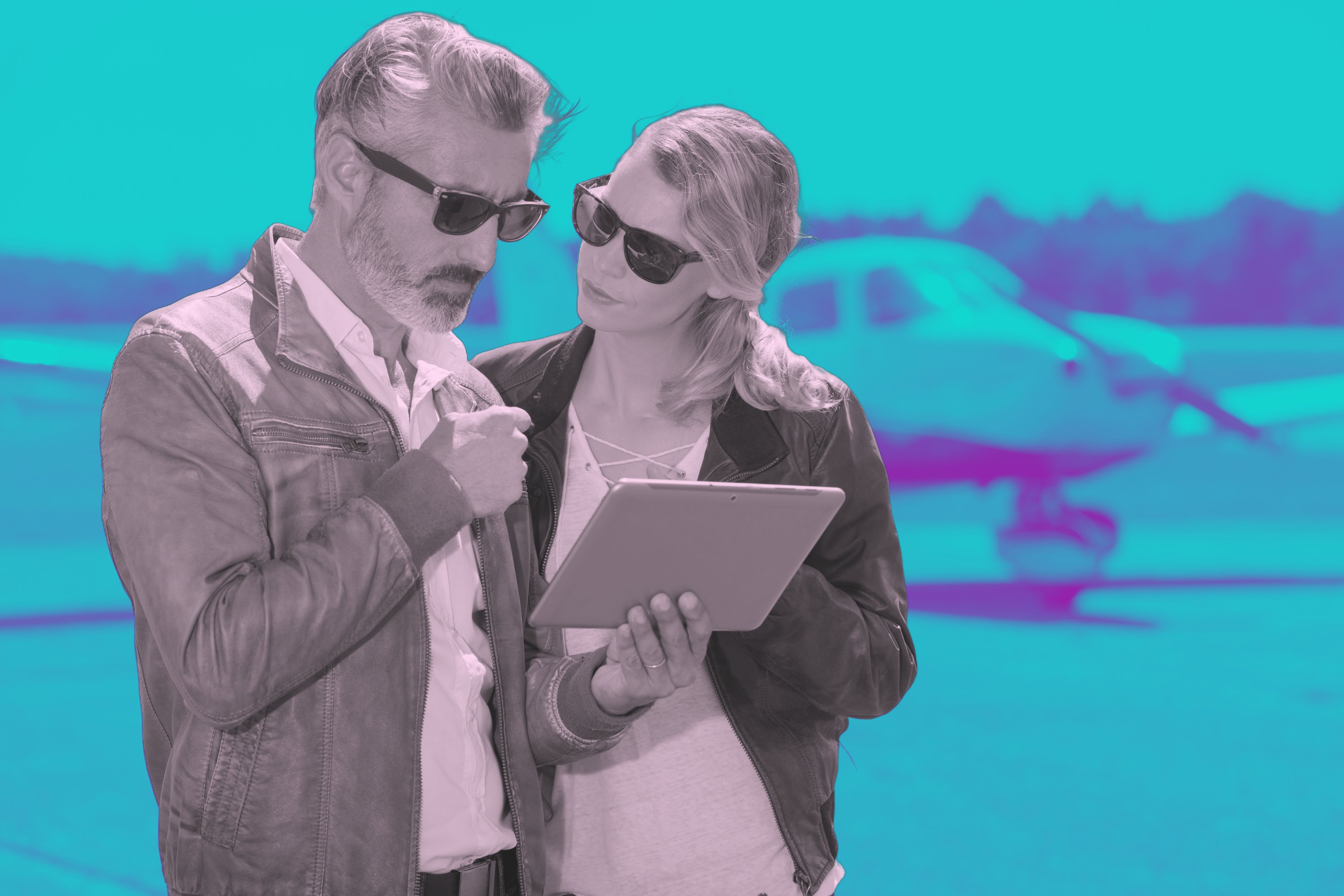 Pilots using a tablet outside airplane