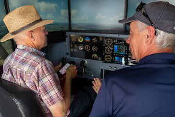 Pilot and instructor in a Redbird AATD