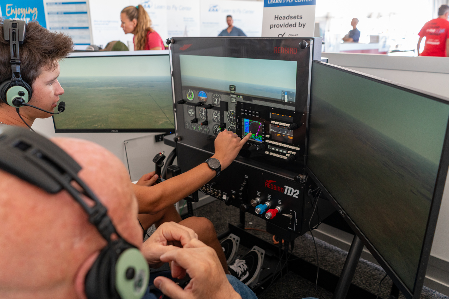 Pilots flying a Redbird TD2 Basic Aviation Training Device