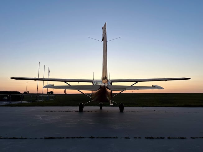 General aviation airplane parked on the ramp at sunset