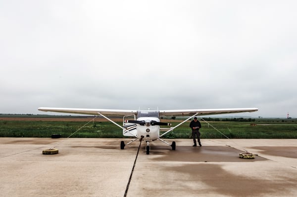 Student pilot consulting his checklist outside a general aviation training airplane