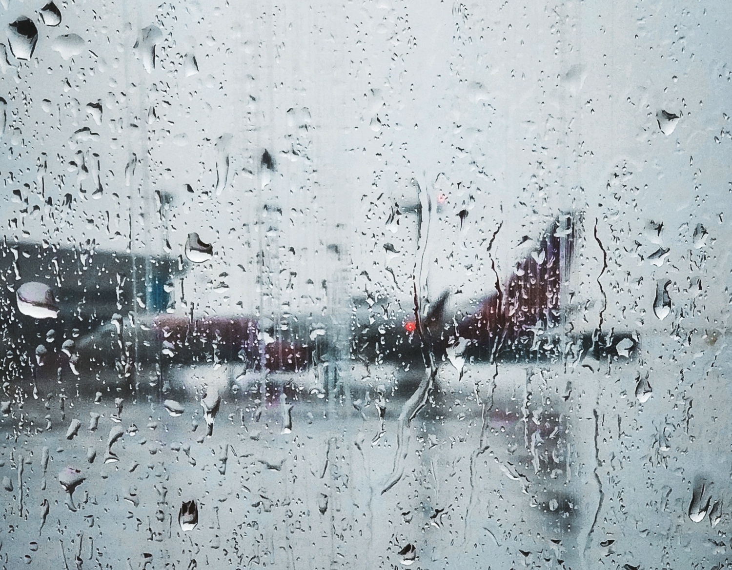Airplane parked on the tarmac on a rainy day