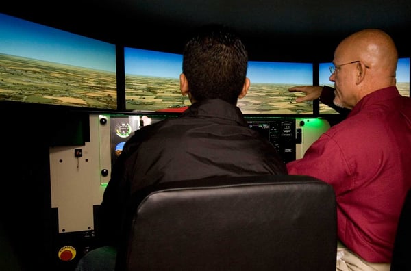 Flight Instructor and Student Pilot in Flight Simulator