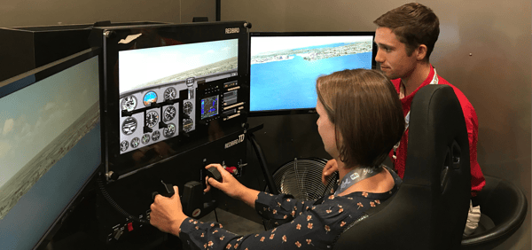 A pilot and instructor flying a Redbird TD