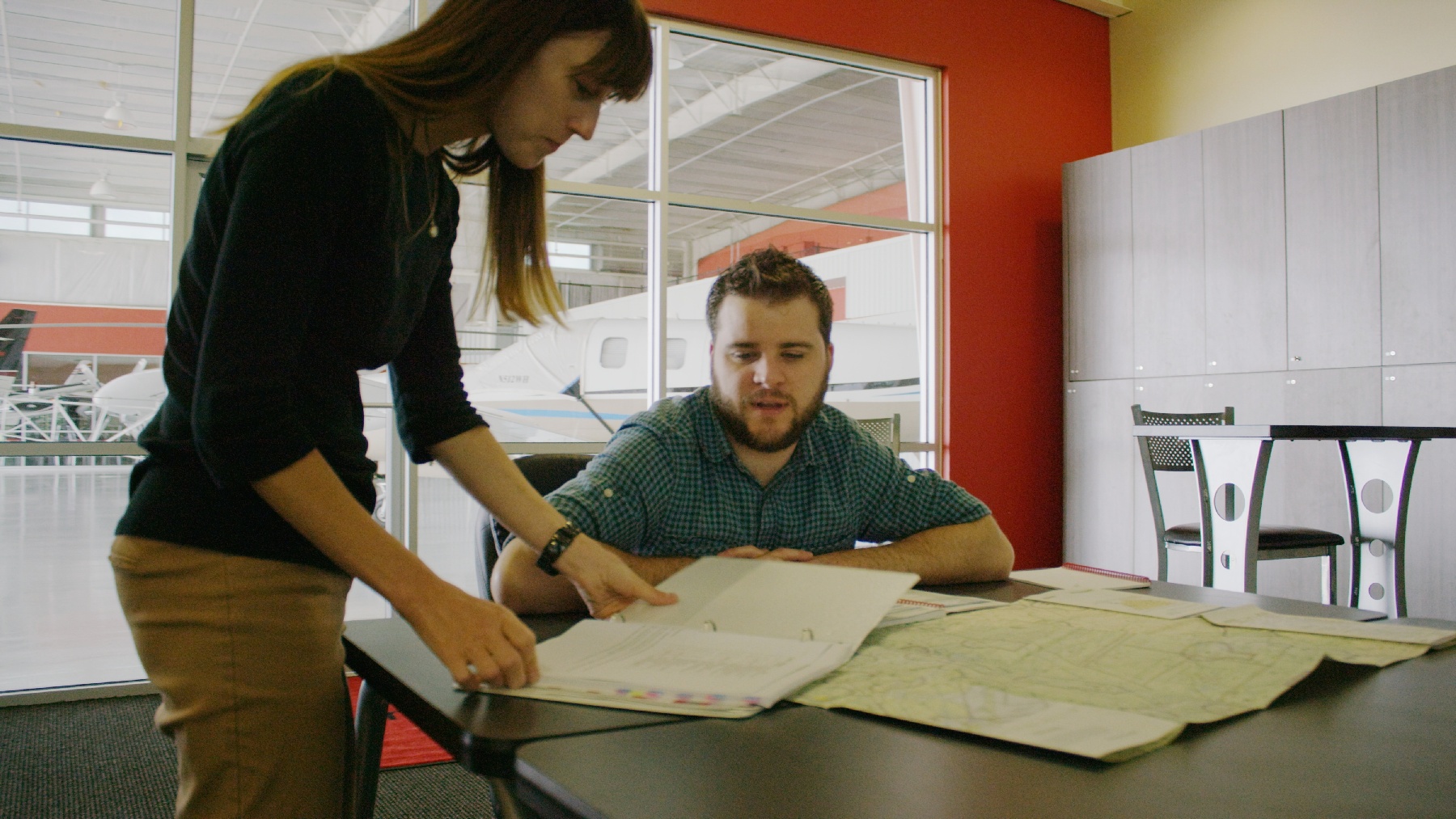 Flight instructor and learner going over a flight lesson at a flight school