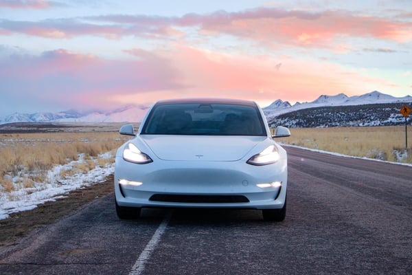 Tesla sedan pulled over to the side of the road in cold weather