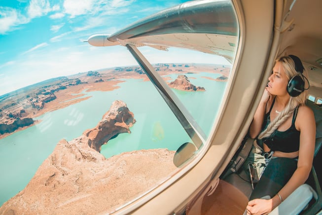 Woman looking out the window of a GA airplane during an aerial tour in Arizona