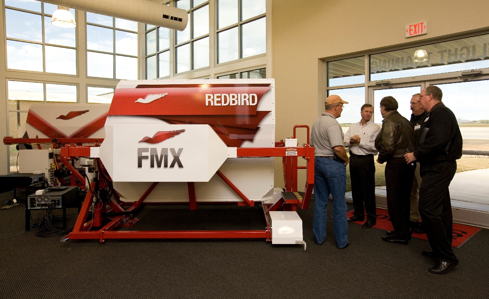 Pilots Conversing Next to Flight Simulators