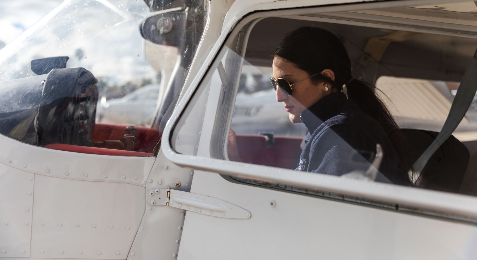 Pilot climbing into airplane