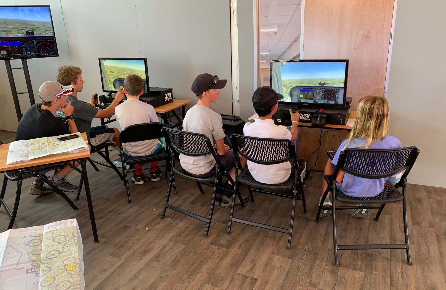 Students Piloting Flight Simulators