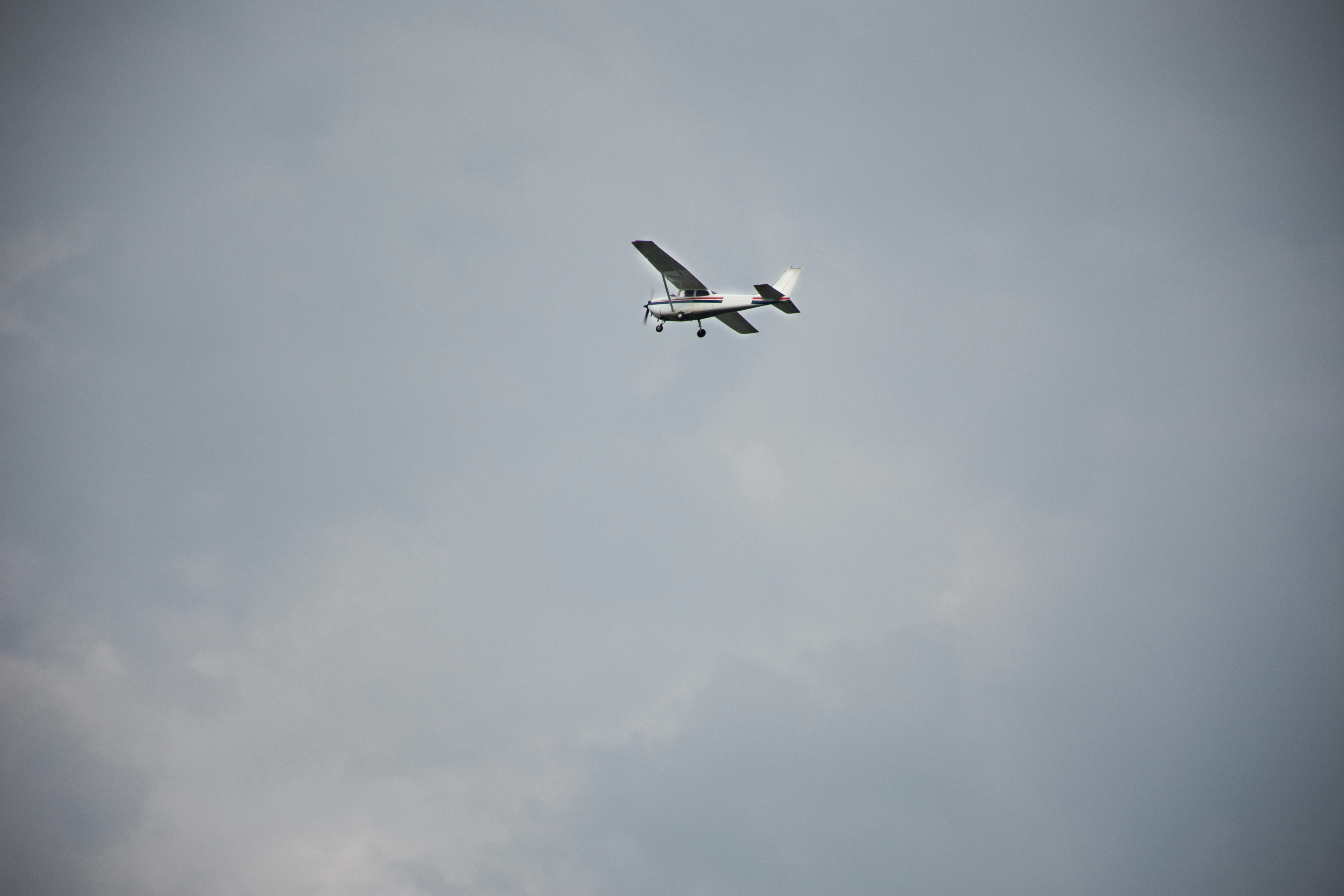 High-wing airplane flying into storm clouds