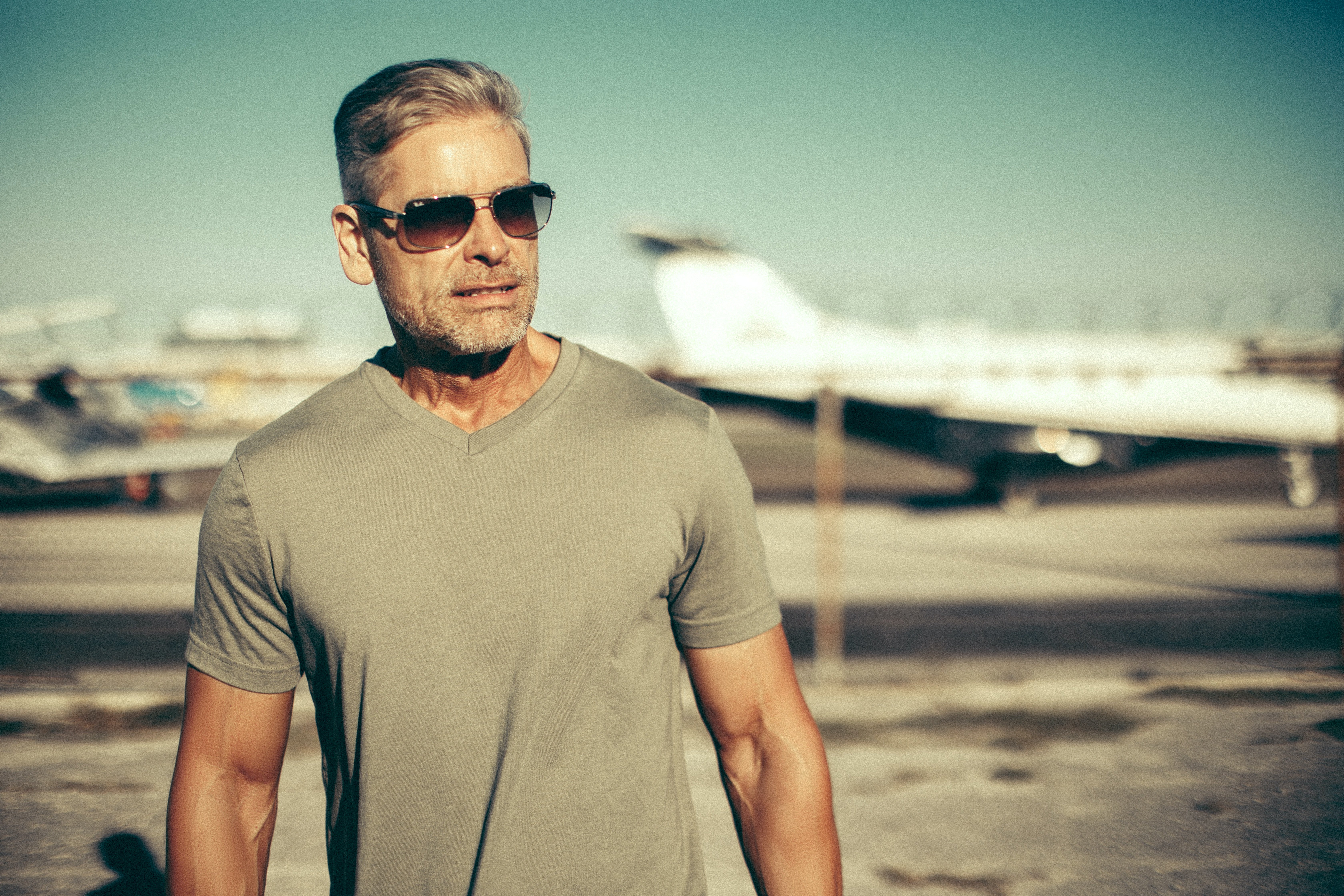 Pilot standing in front of his airplane at the airport