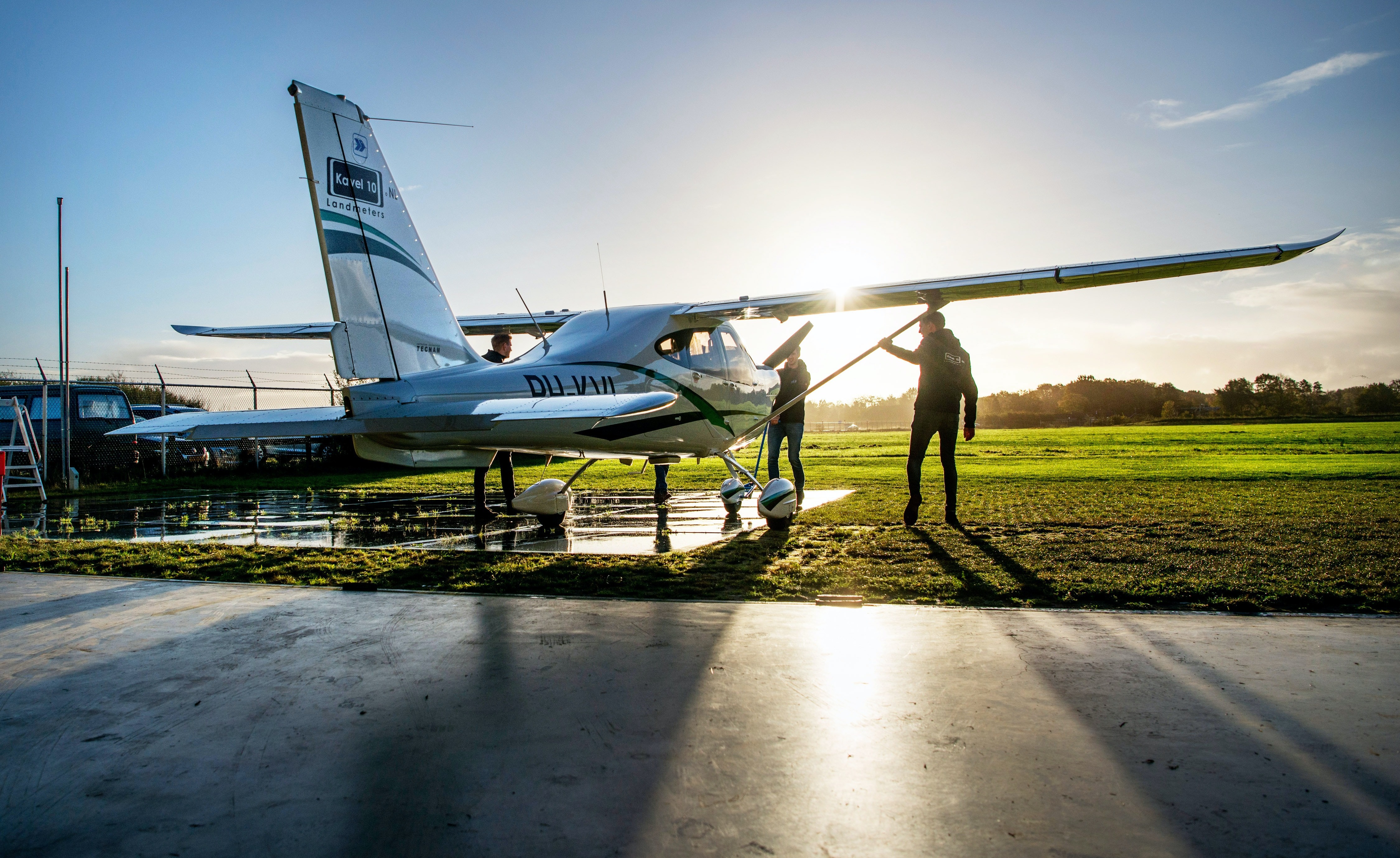 Student pilot and certified flight instructor conduct a preflight inspection on a general aviation airplane