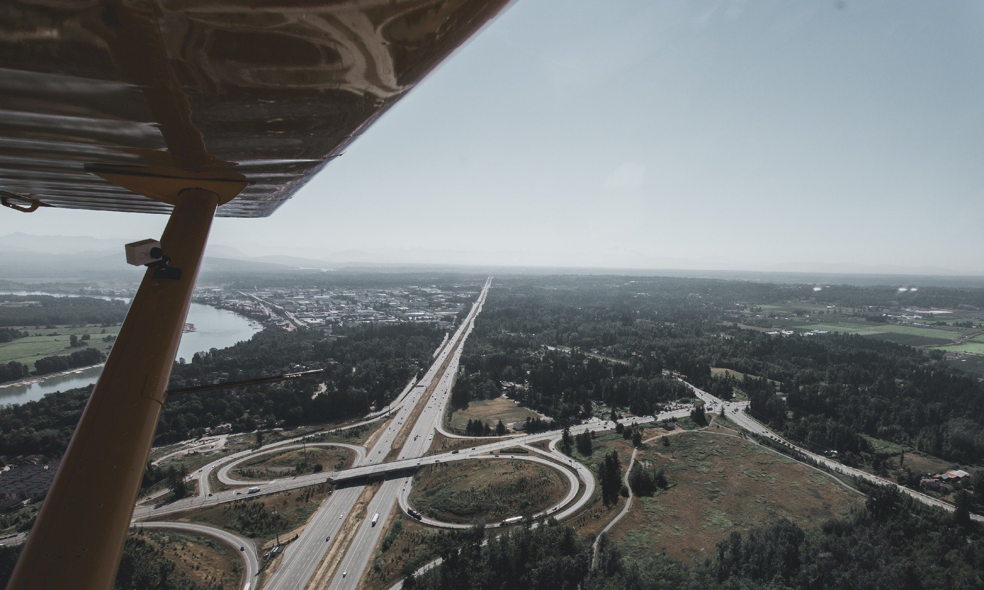 General aviation airplane performing an S-turn over a road 