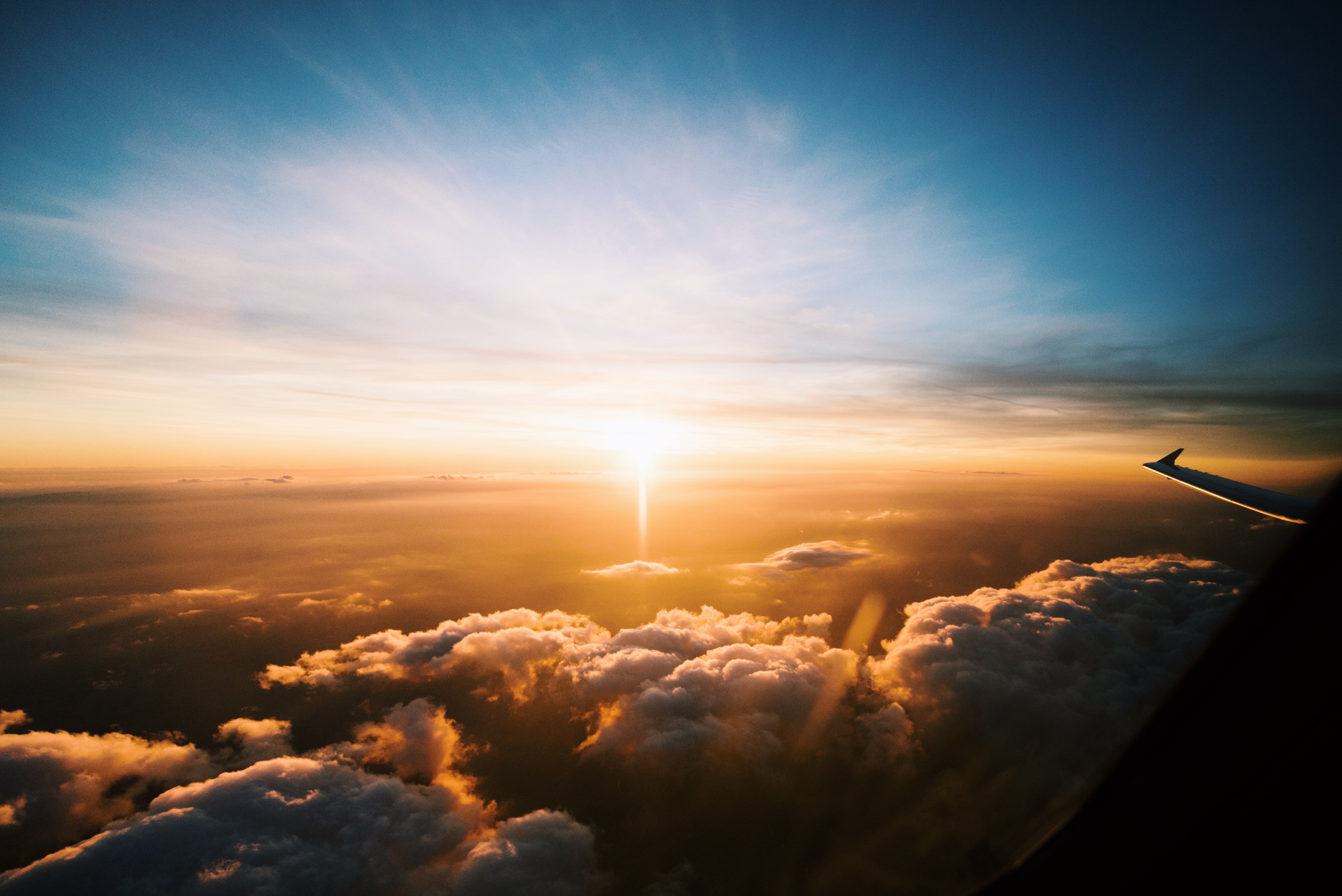 Wingtip over the clouds at sunset