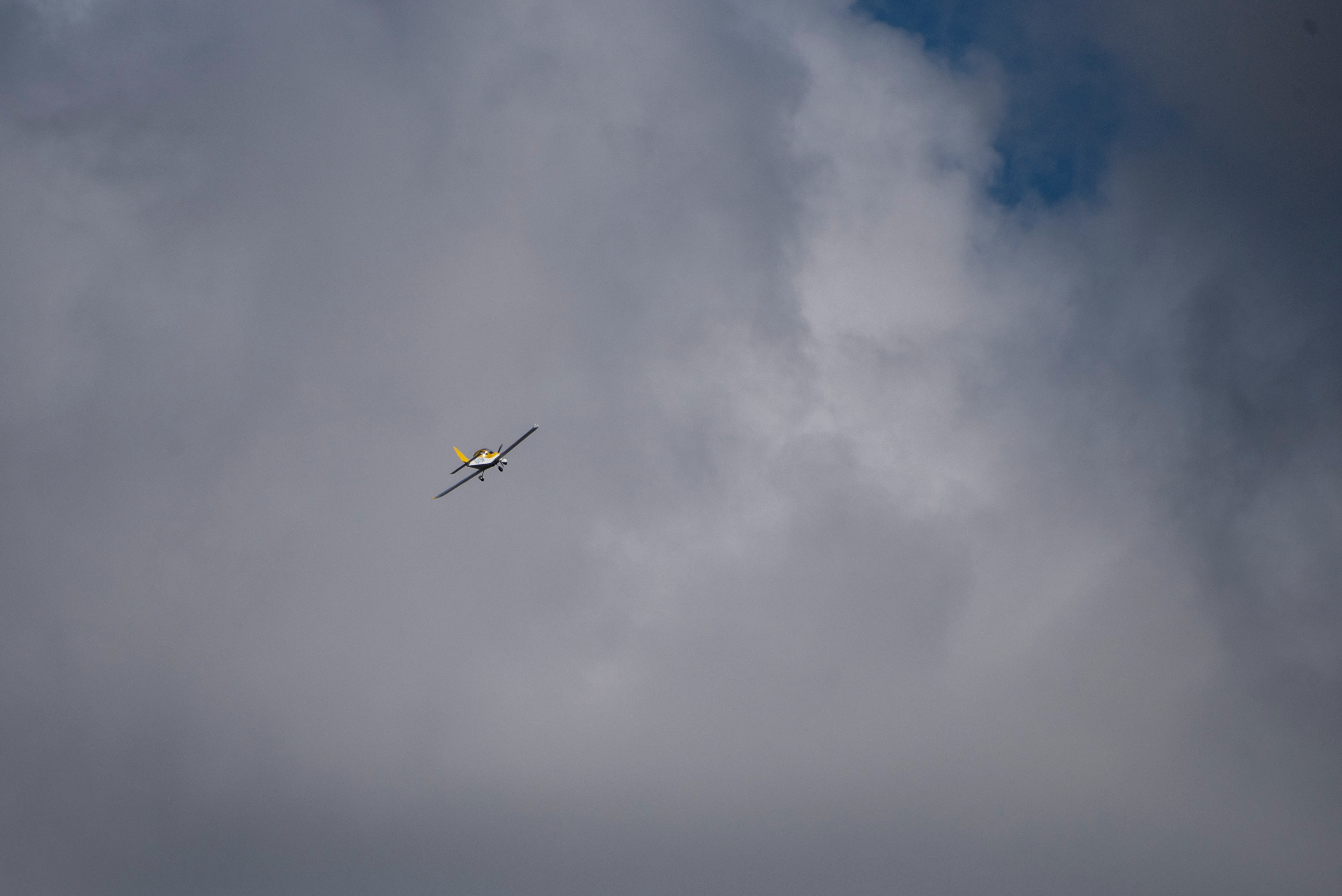 General aviation training airplane ascending into the clouds